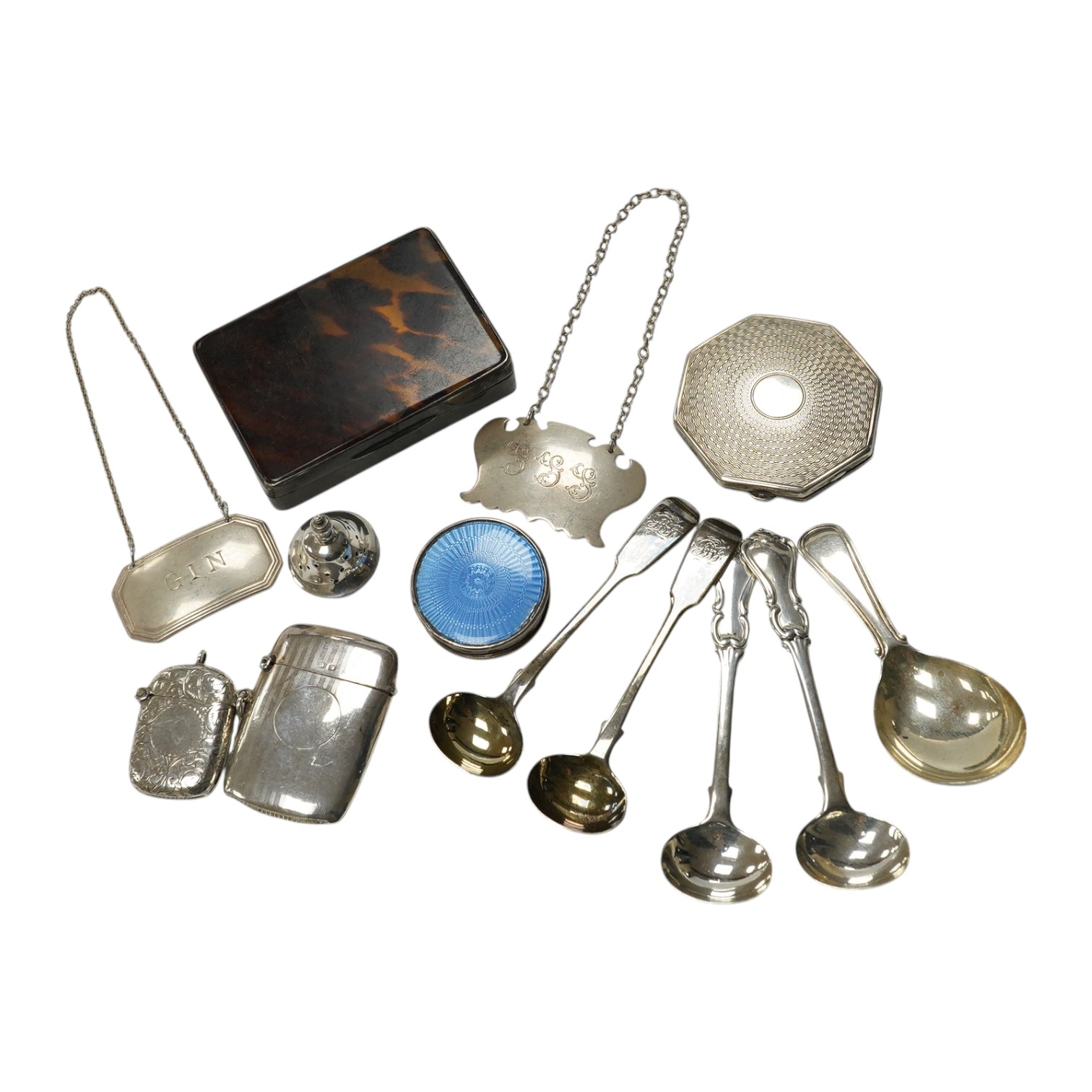 Assorted small silver items including two vesta cases, caddy spoons, mustard ladles, enamelled pill box, wine labels etc. Condition - poor to fair to good